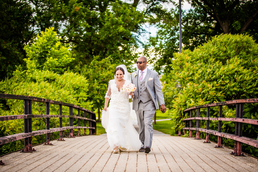 Bride and groom walk to their reception during their Promontory Point wedding 