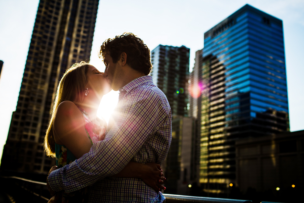 couple silhouetted during their wrigley building engagement session 