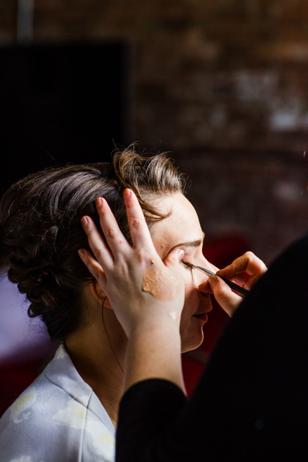 Bride gets her makeup done before her Ovation Chicago wedding.
