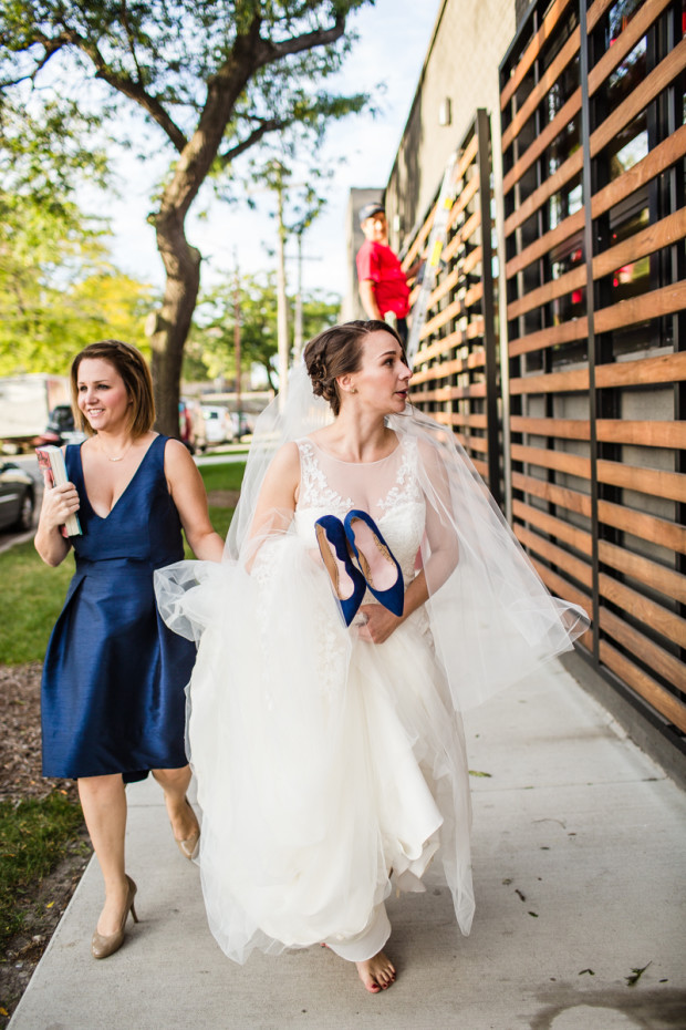 Bride walks around the corner shoeless before an Ovation Chicago wedding ceremony.