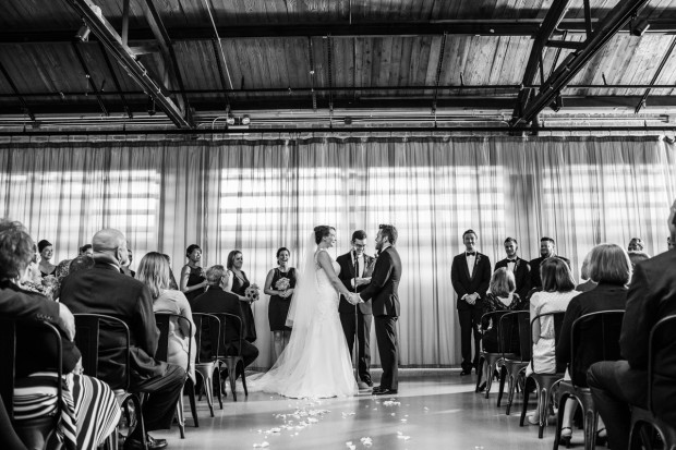 Bride and groom hold hands during their Ovation Chicago wedding ceremony.