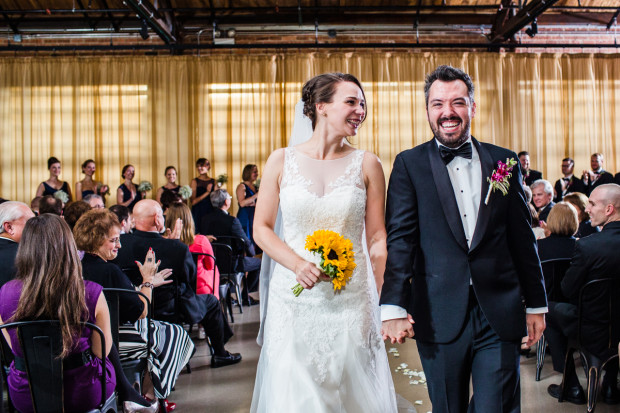 Bride and groom walk down the aisle together during an Ovation Chicago wedding ceremony.