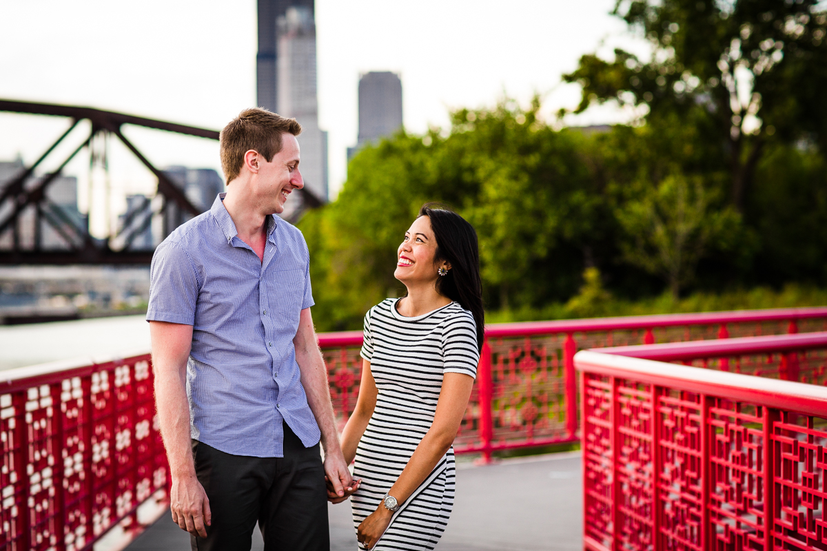 A couple on a red bridge during their Ping Tom Park engagement session