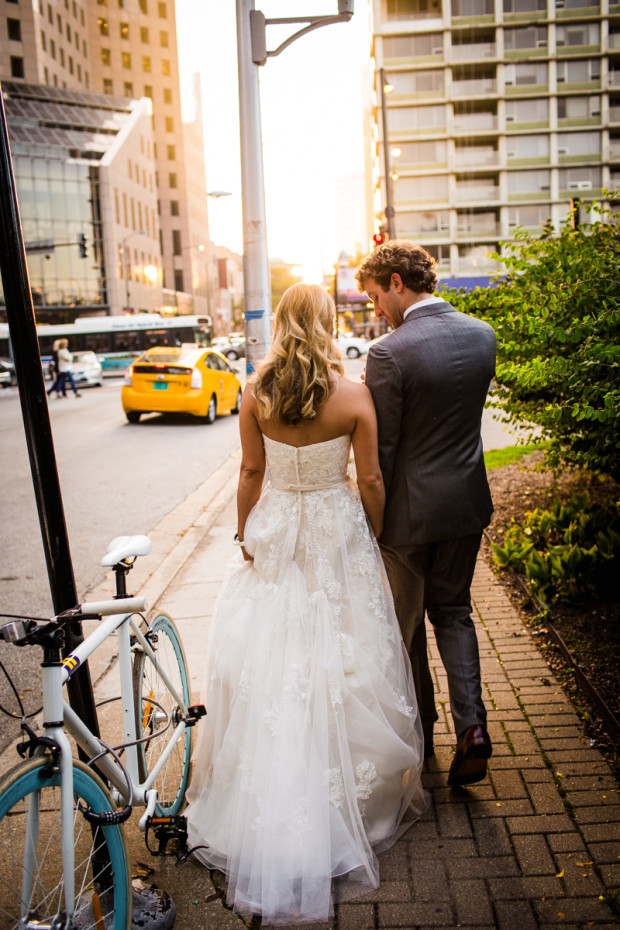 Bride and groom walk on Michigan Avenue during their Spiaggia wedding.