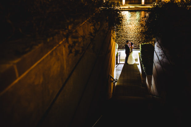 Couple kisses at night during their Westin River North wedding.