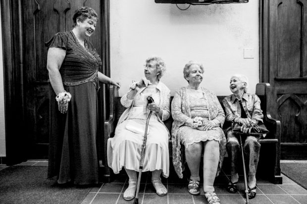 Guests chat before a wedding ceremony at Sacred Heart Church in Winnetka.