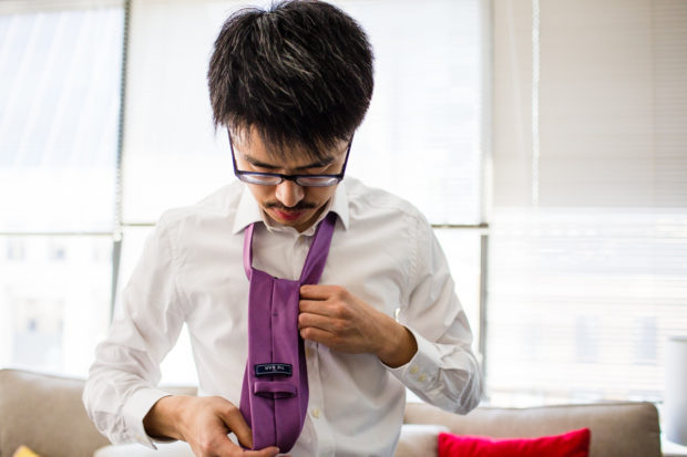 Groom gets ready at his apartment before a Greenhouse Loft wedding.