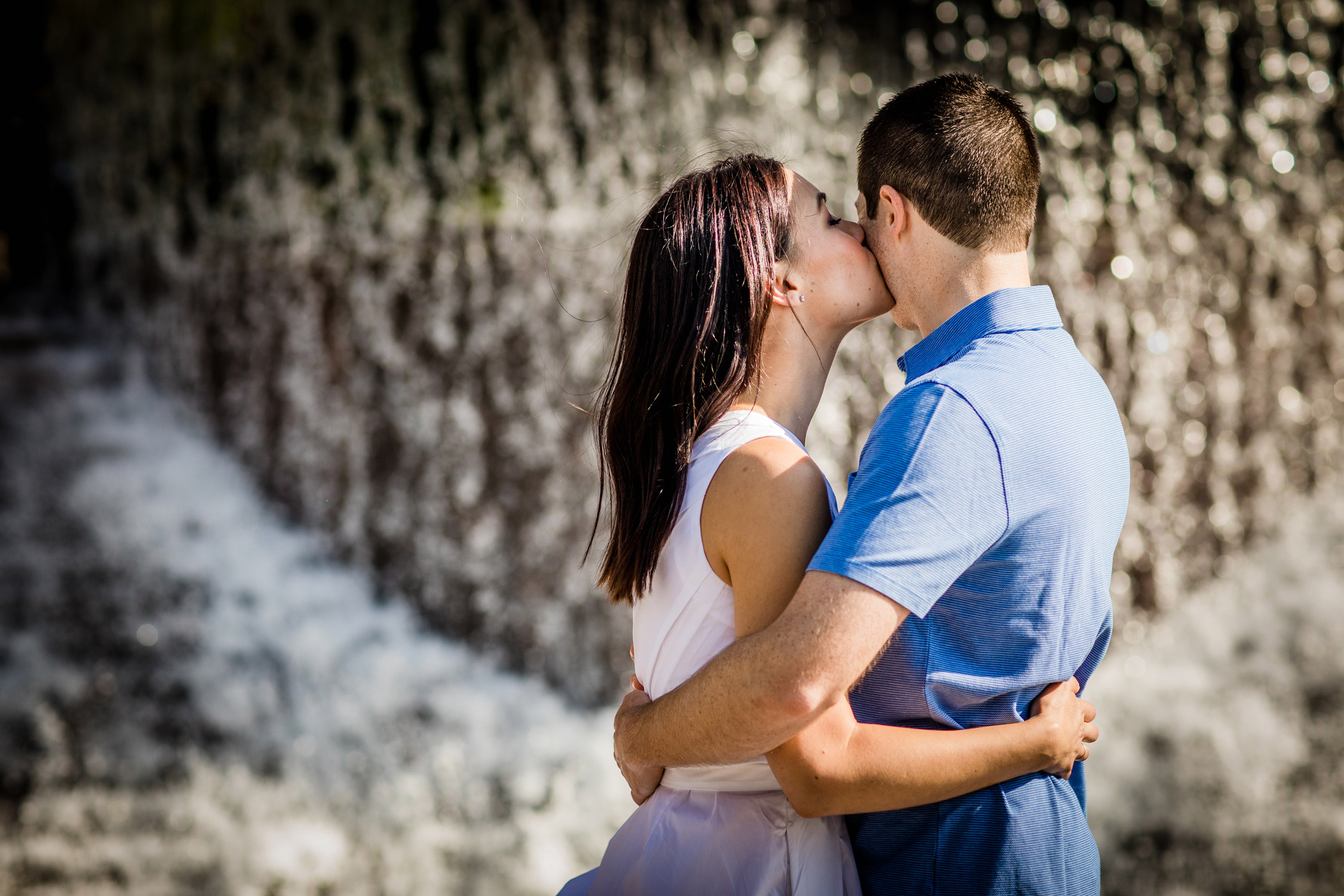 Couple hugs during a Riverwalk engagement session.