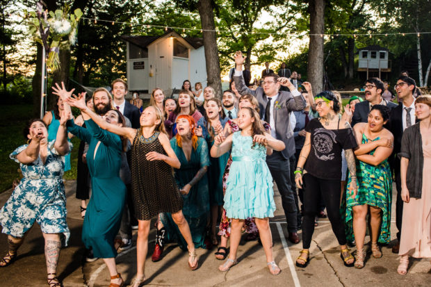 Guests try to catch the bouquet at a Camp Wandawega wedding.