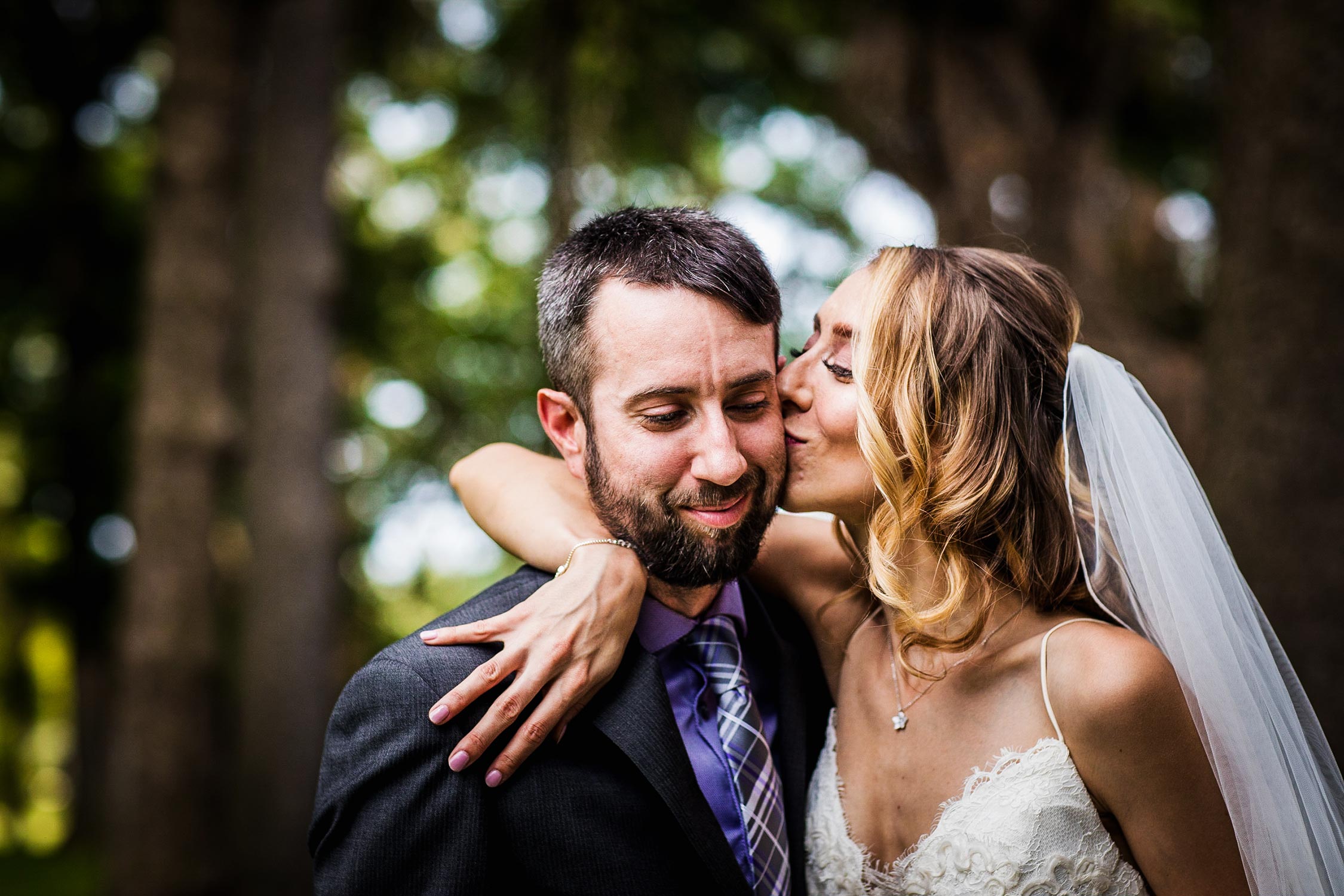 A bride kisses her groom on the cheek during a Katherine Legge Memorial Lodge wedding.