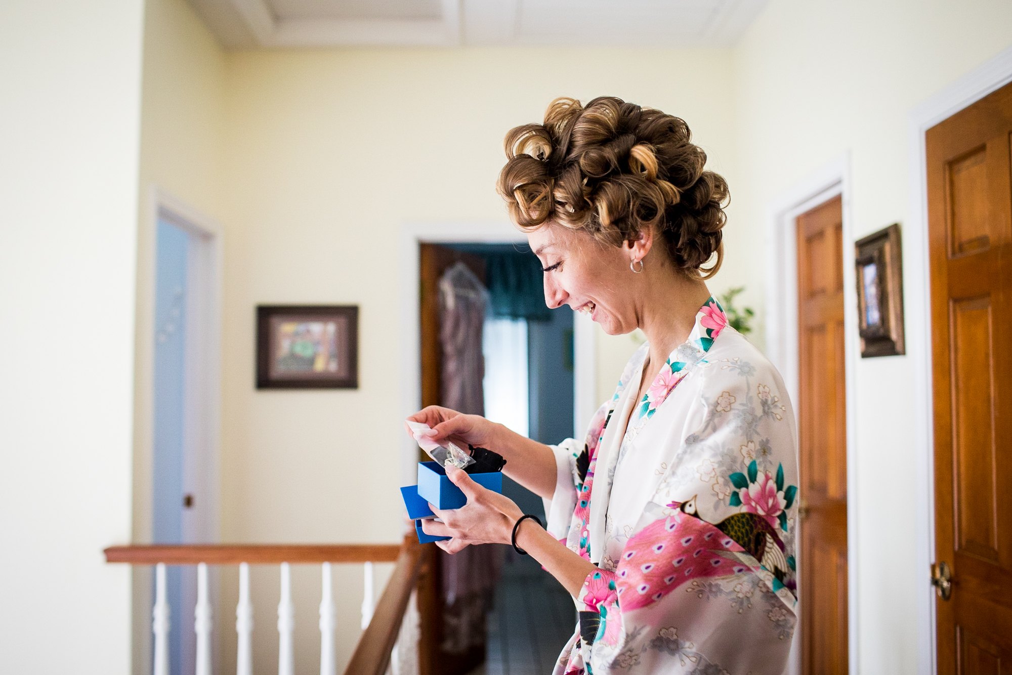 Bride opens a gift before her Katherine Legge Memorial Lodge wedding.