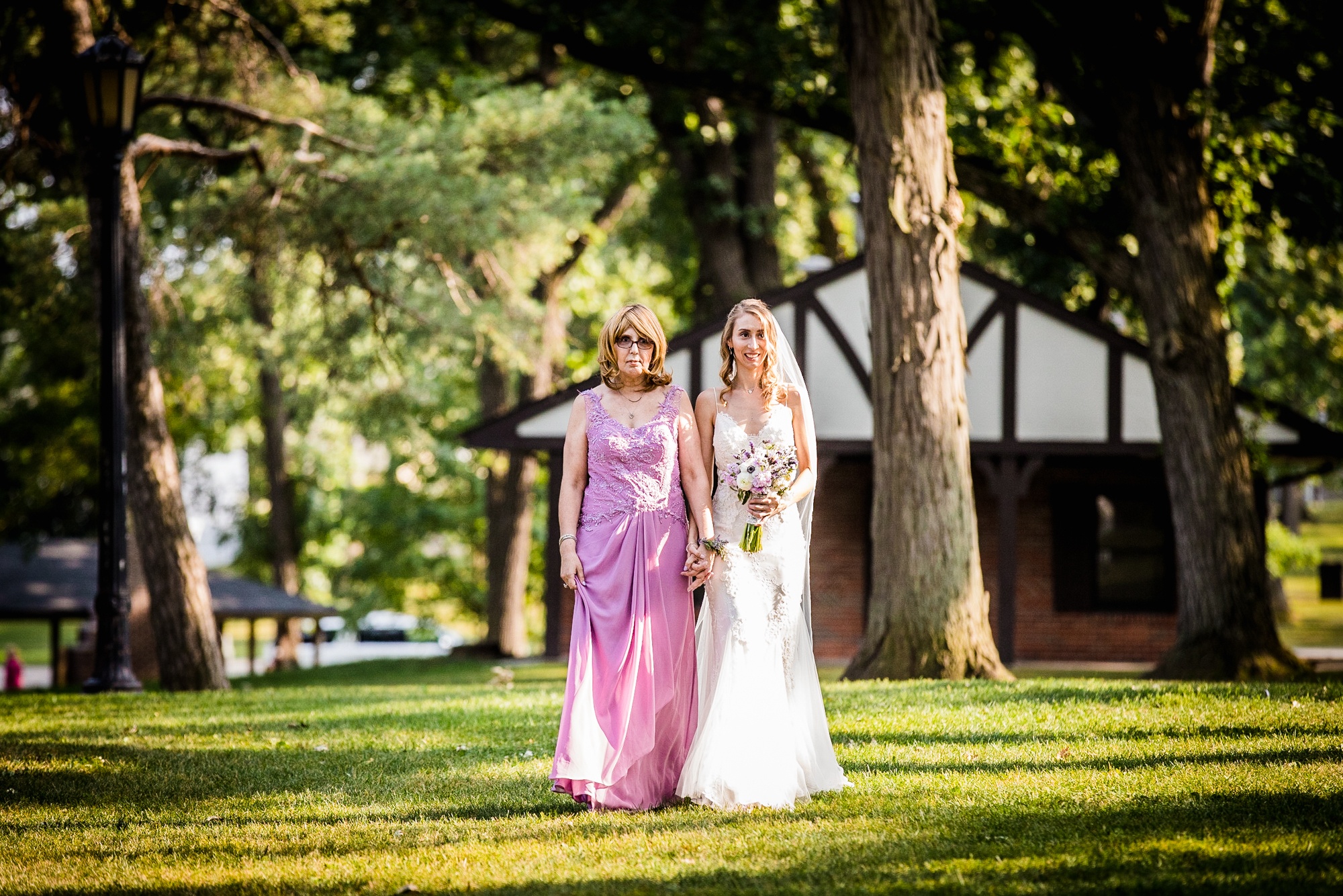 A bride and her mother walk down the aisle at a Katherine Legge Memorial lodge wedding
