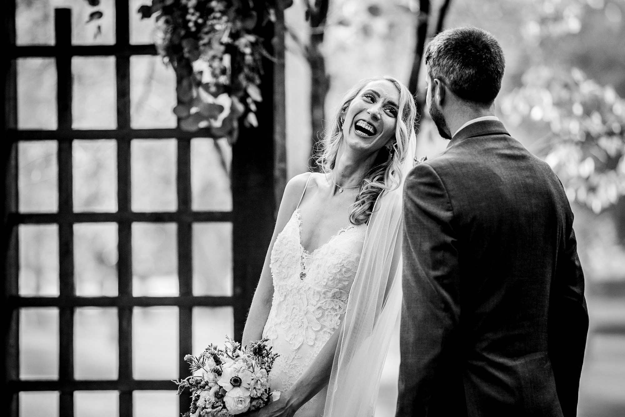 A bride laughs with her groom at a Katherine Legge Memorial lodge wedding