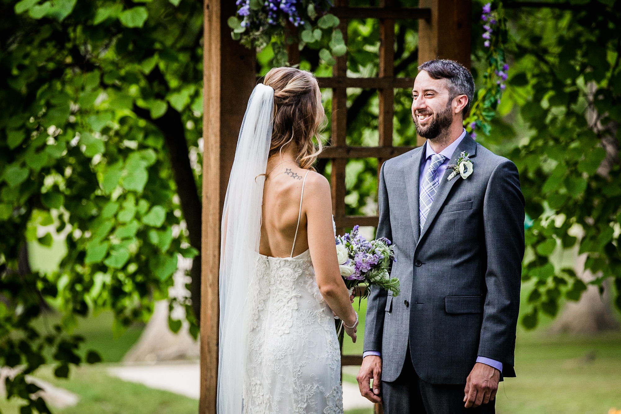 A groom laughs with his bride at a Katherine Legge Memorial lodge wedding ceremony