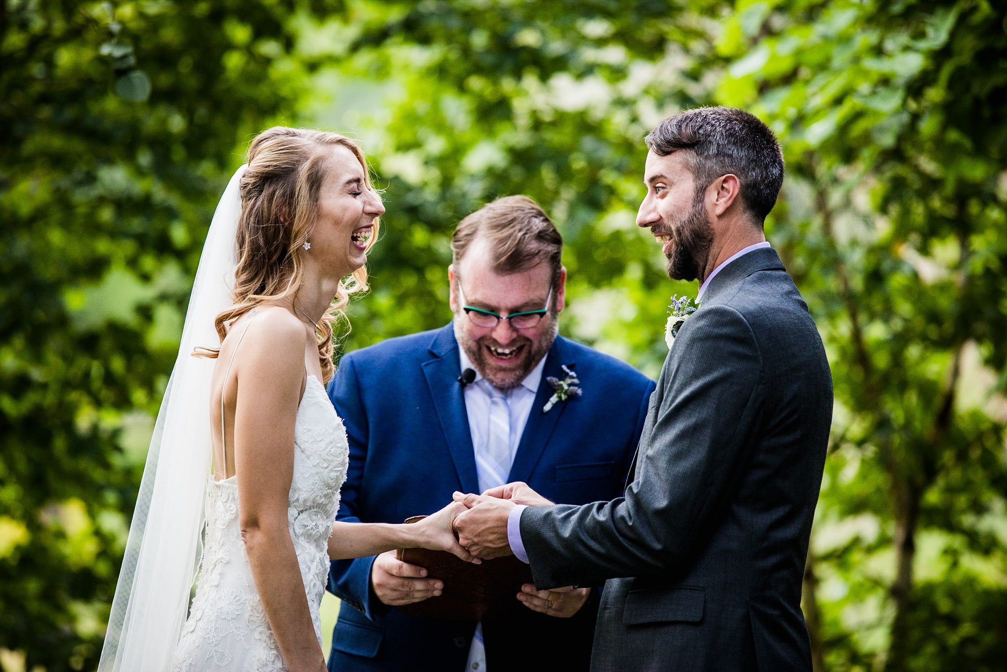 A couple laughs together during a Katherine Legge Memorial lodge wedding ceremony