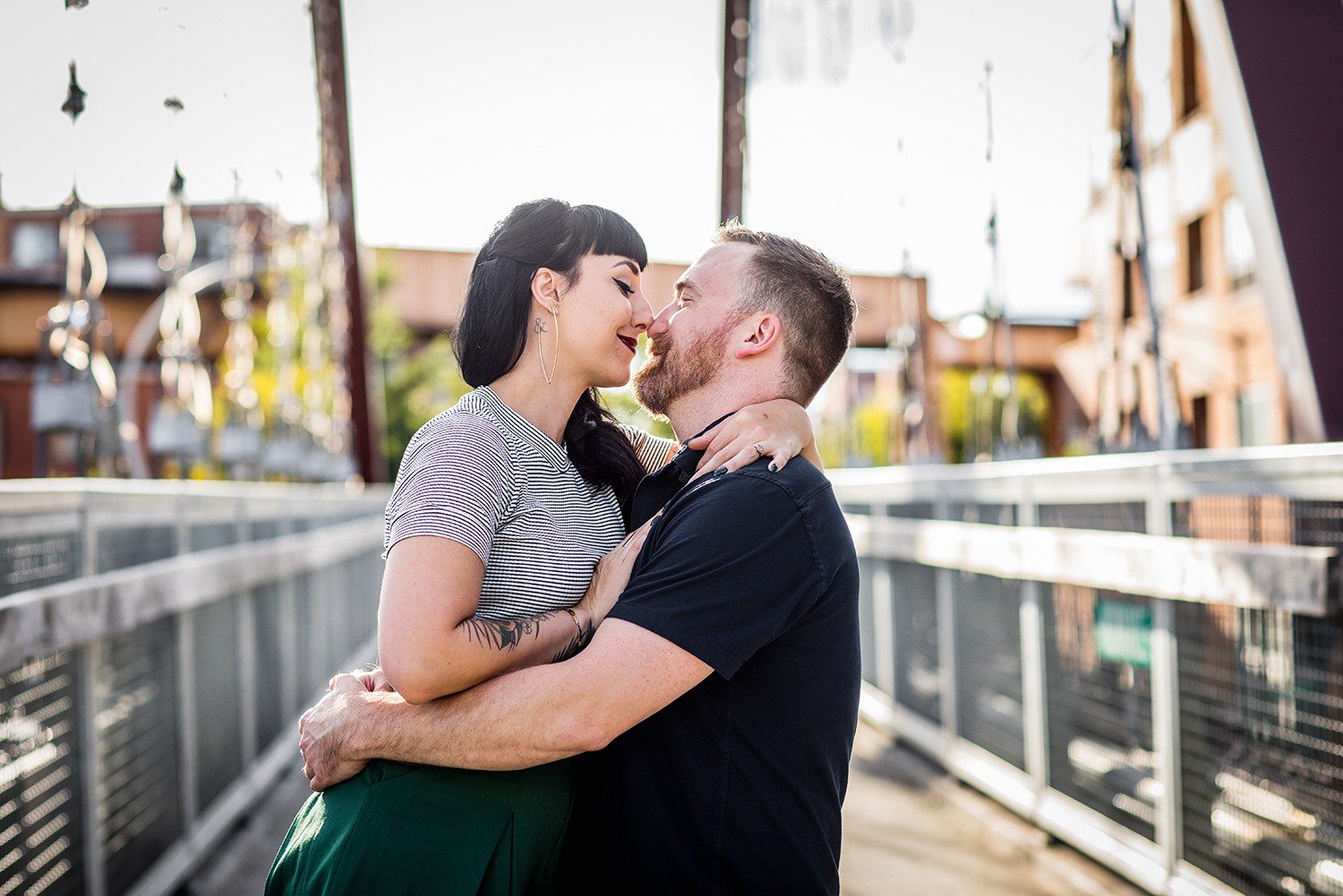 A couple hugs each other on the 606 during their Logan Square engagement session in Chicago. 