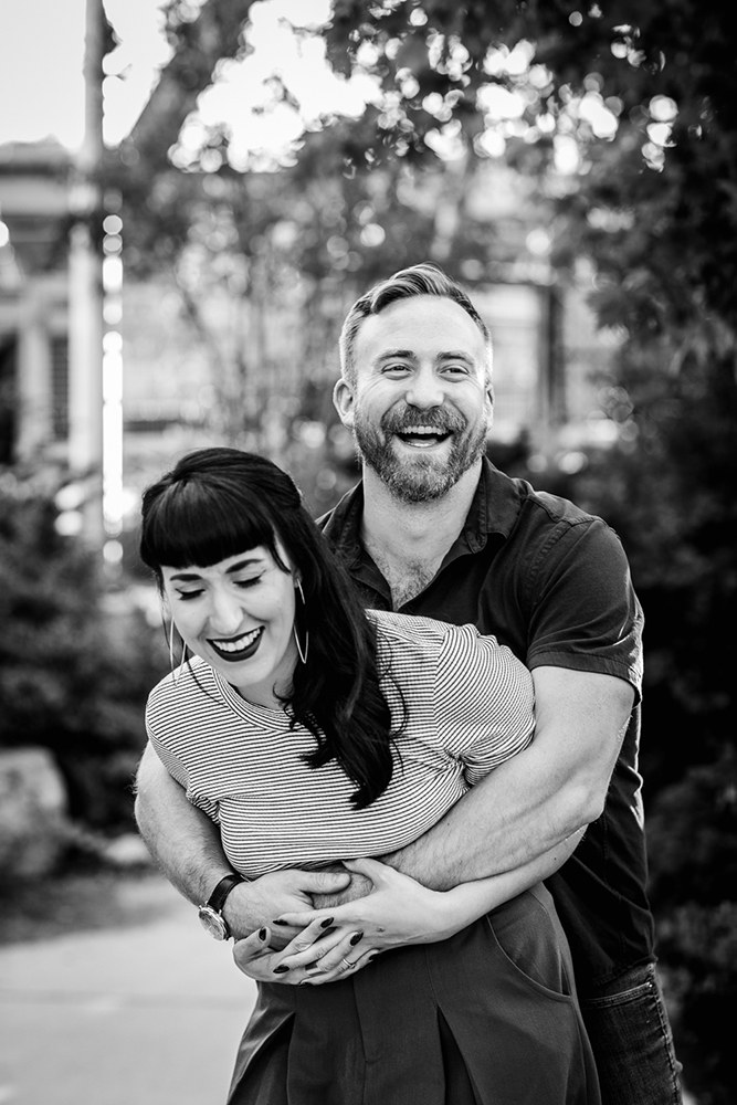 A couple laughs together during their Logan Square engagement session in Chicago. 