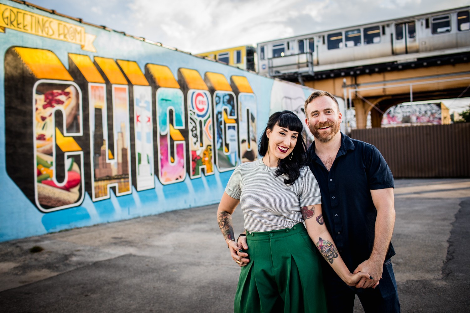 A couple portrait in front of the 'Chicago' mural during their Logan Square engagement session in Chicago. 