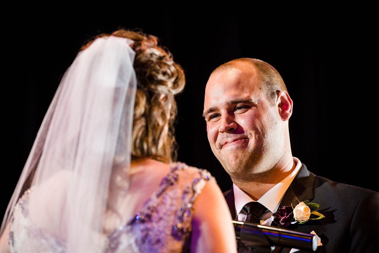 A groom looks at his bride during a ceremony at a Mayne Stage wedding in Chicago. 
