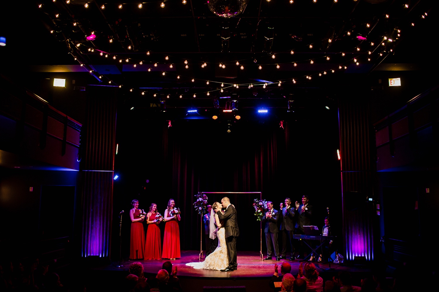 A couple shares their first kiss at a Mayne Stage wedding in Chicago. 