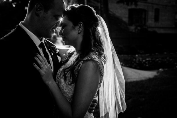 A couple hugs each other in the sunset during a Mayne Stage wedding in Chicago.