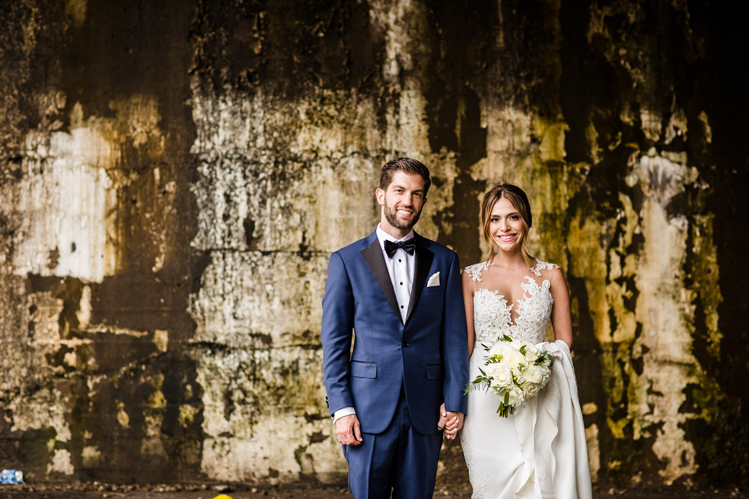 A bride and groom pose for a portrait before their Gallery Marchetti wedding.