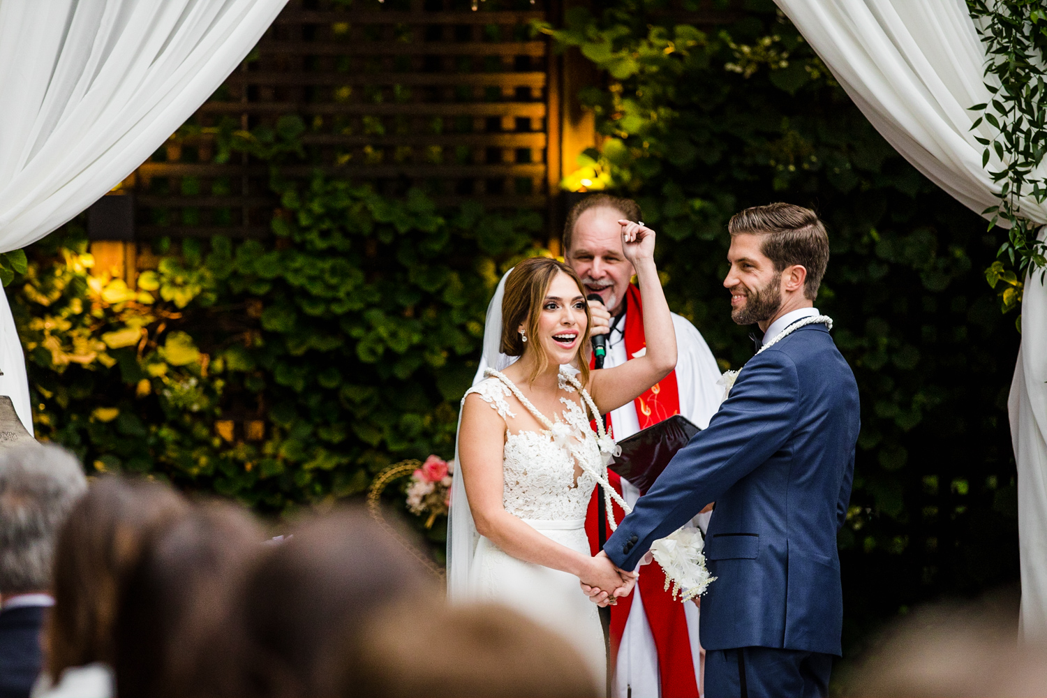 A bride and groom laugh together during their Gallery Marchetti wedding ceremony.