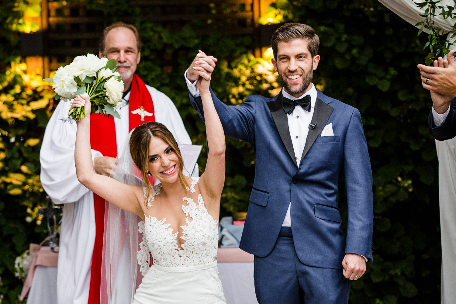 A bride and groom celebrate at the end of their Gallery Marchetti wedding ceremony.