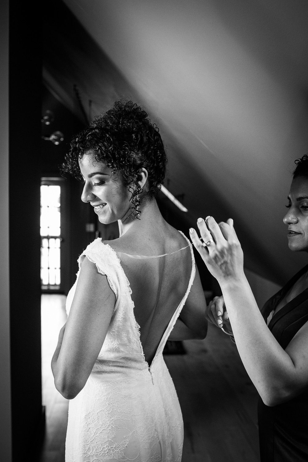 A bride puts her wedding dress on before a Garfield Park Conservatory wedding in Chicago. 