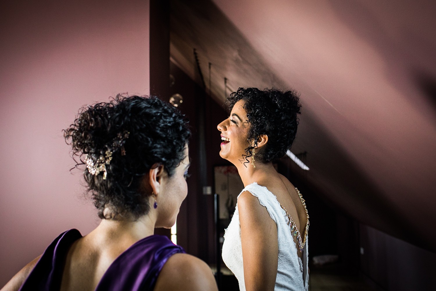 A bride laughs while getting ready before her Garfield Park Conservatory wedding. 