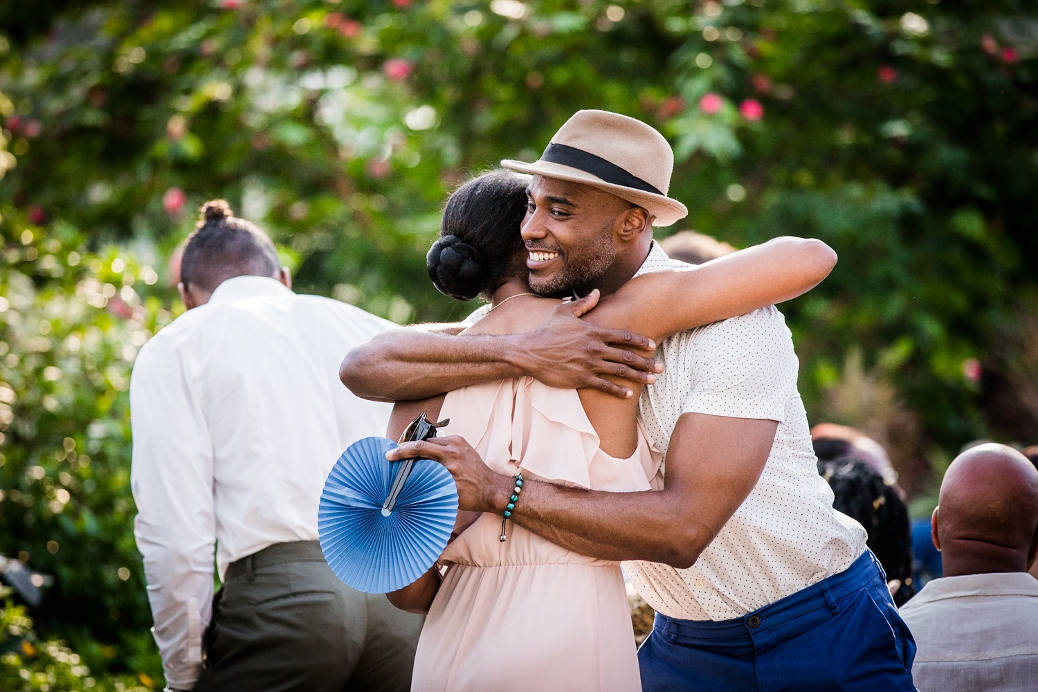 Guests hug before a Garfield Park Conservatory wedding.