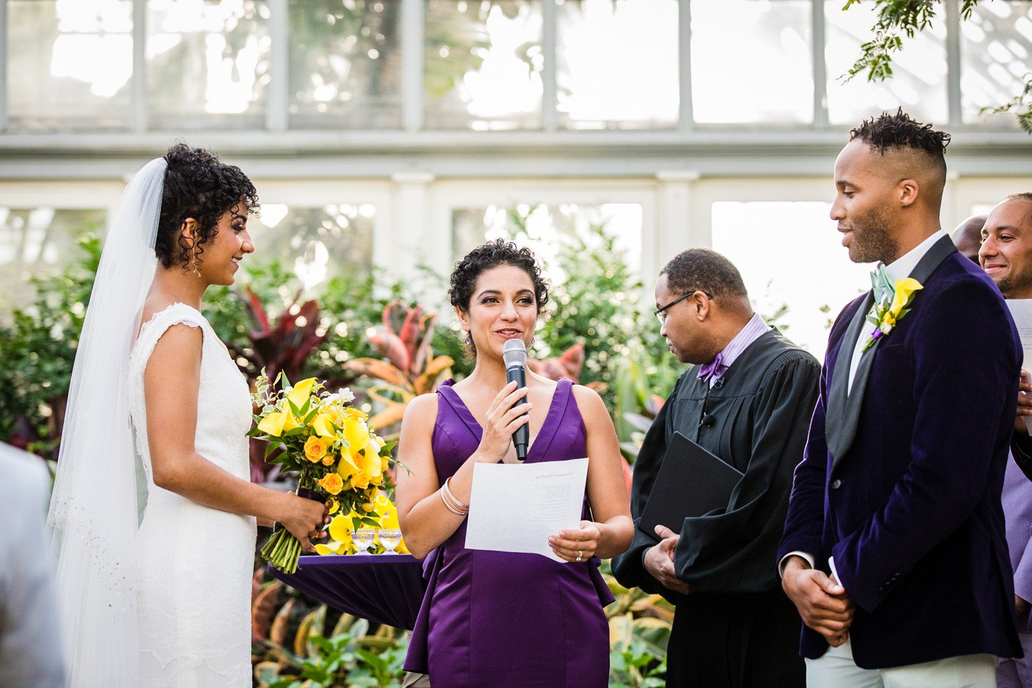 A bridesmaid does a reading at a Garfield Park Conservatory wedding. 