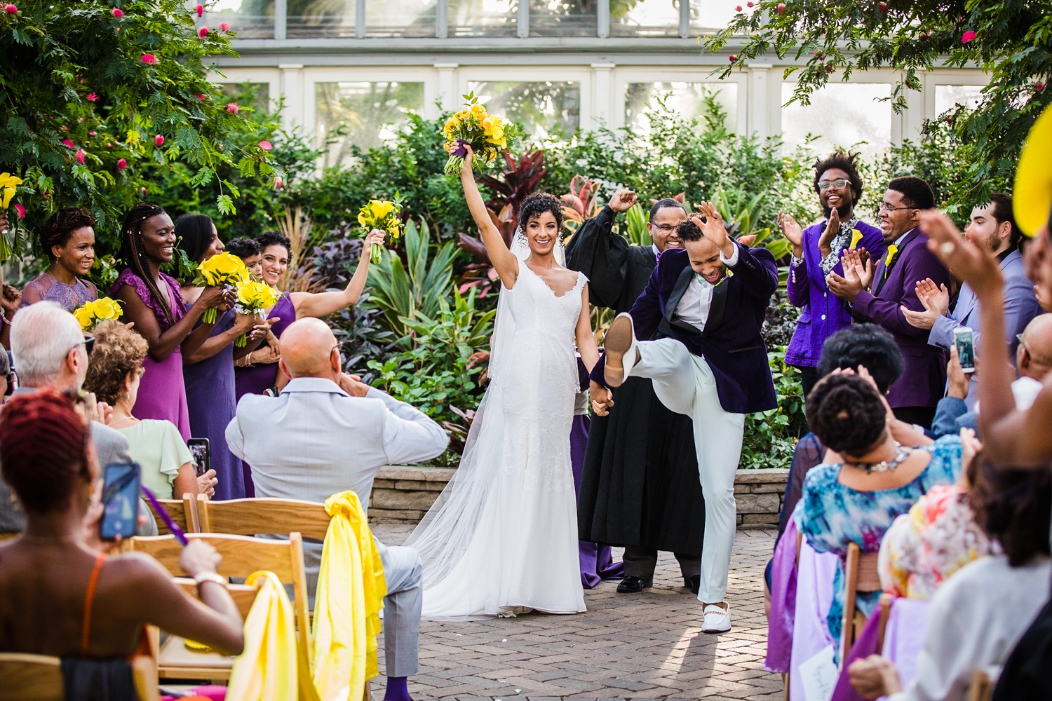 A couple celebrates at the end of their Garfield Park Conservatory wedding ceremony.
