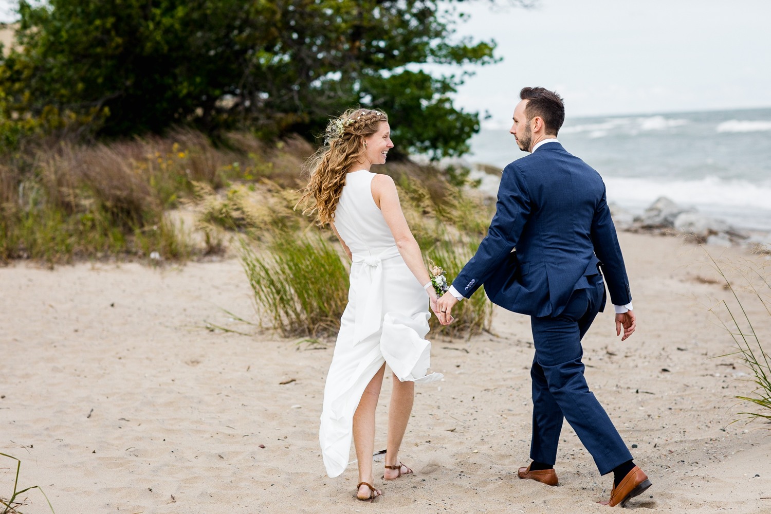A couple walks along the beach together at an Illinois Beach Resort wedding