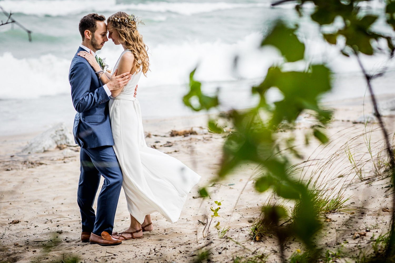 A couple shares a hug together along Lake Michigan at an Illinois Beach Resort wedding