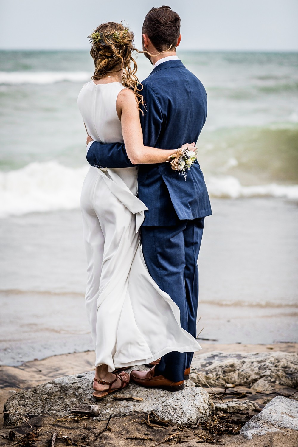 A couple looks out onto the water during an Illinois Beach Resort wedding