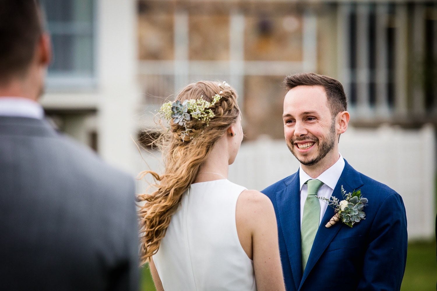 A groom smiles at his bride during an Illinois Beach Resort wedding ceremony.