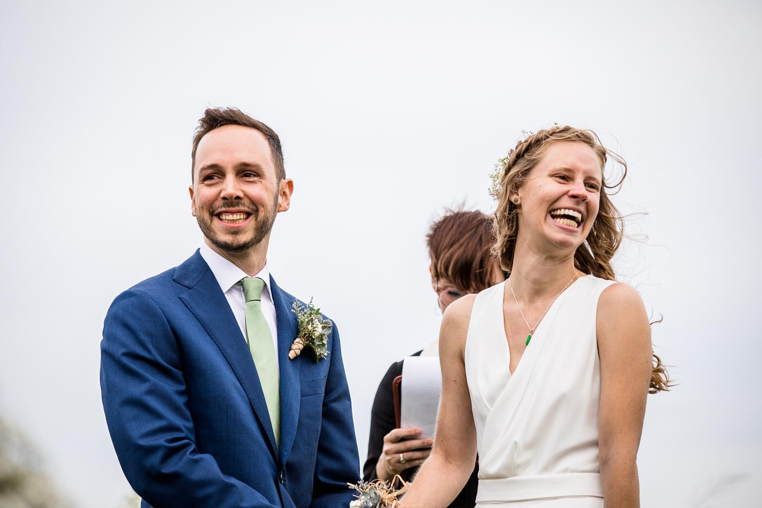 A bride and groom laugh together during Illinois Beach Resort wedding ceremony