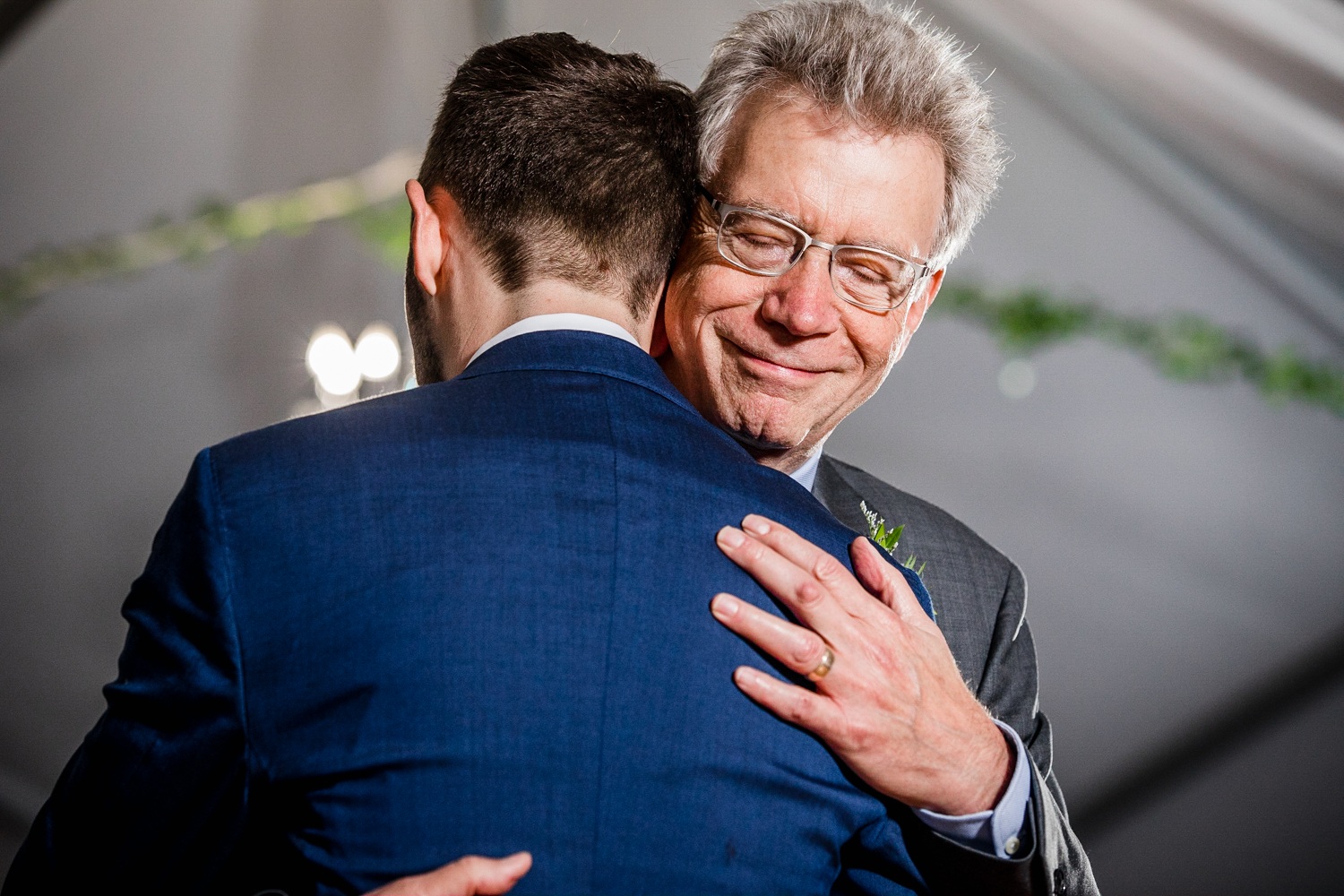 A groom shares a dance with his father at an Illinois Beach Resort wedding