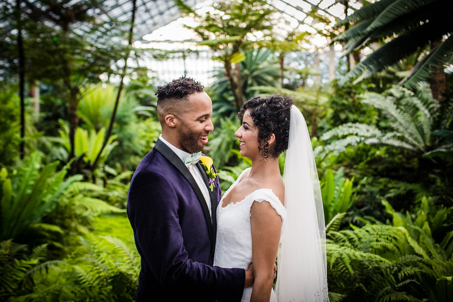 A couple laughs together during a Garfield Park Conservatory wedding. 