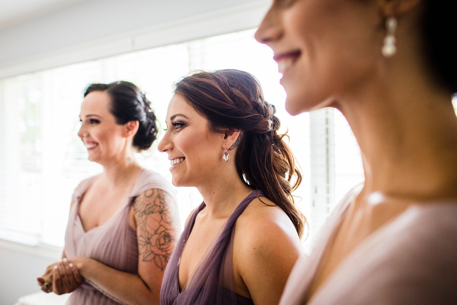 Bridesmaids react to seeing their friend in her wedding dress before a Glen Club wedding. 