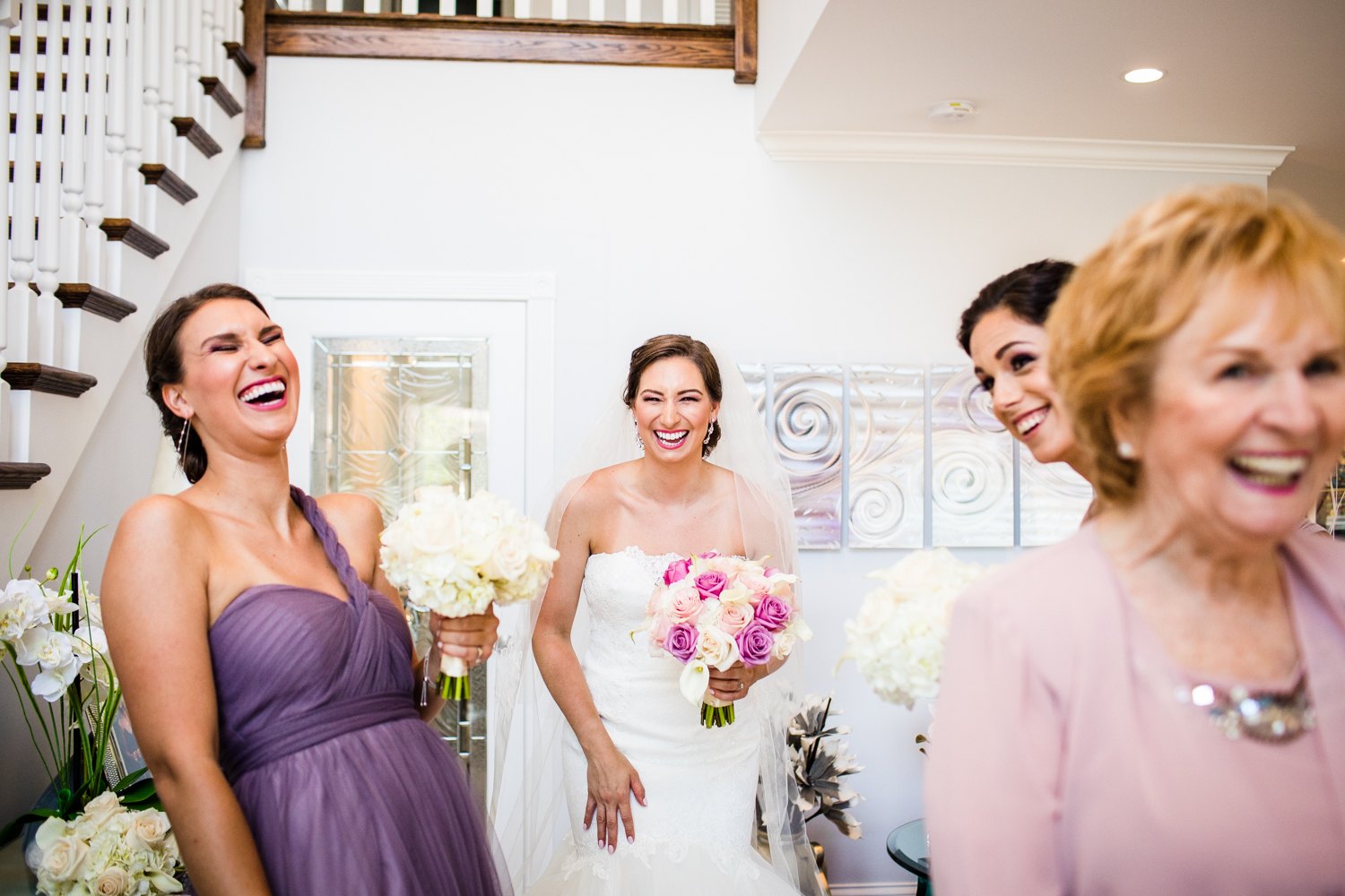 A bride and her wedding party laugh together before a Glen Club wedding. 