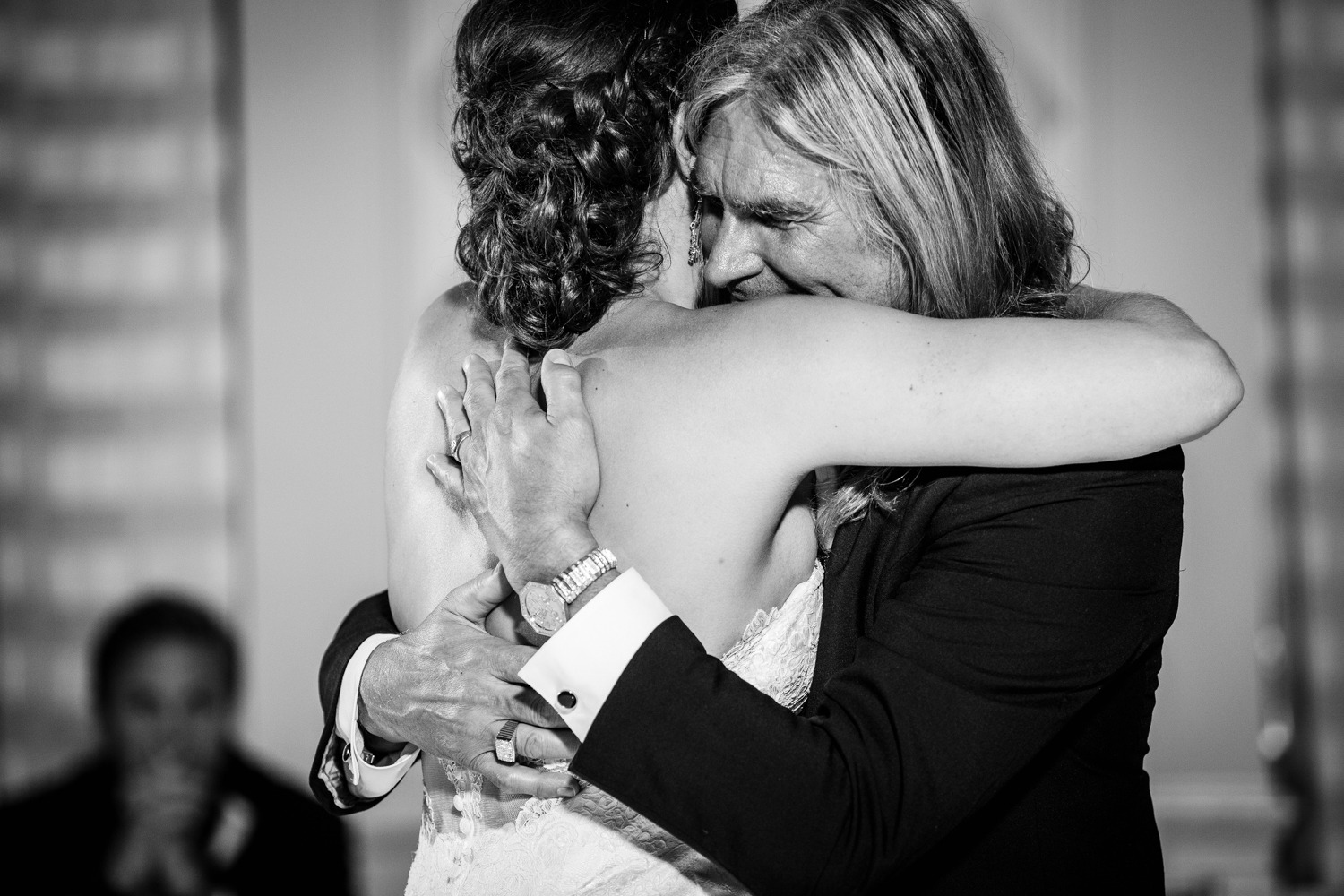 A father hugs his daughter during their first dance during a Glen Club wedding reception. 