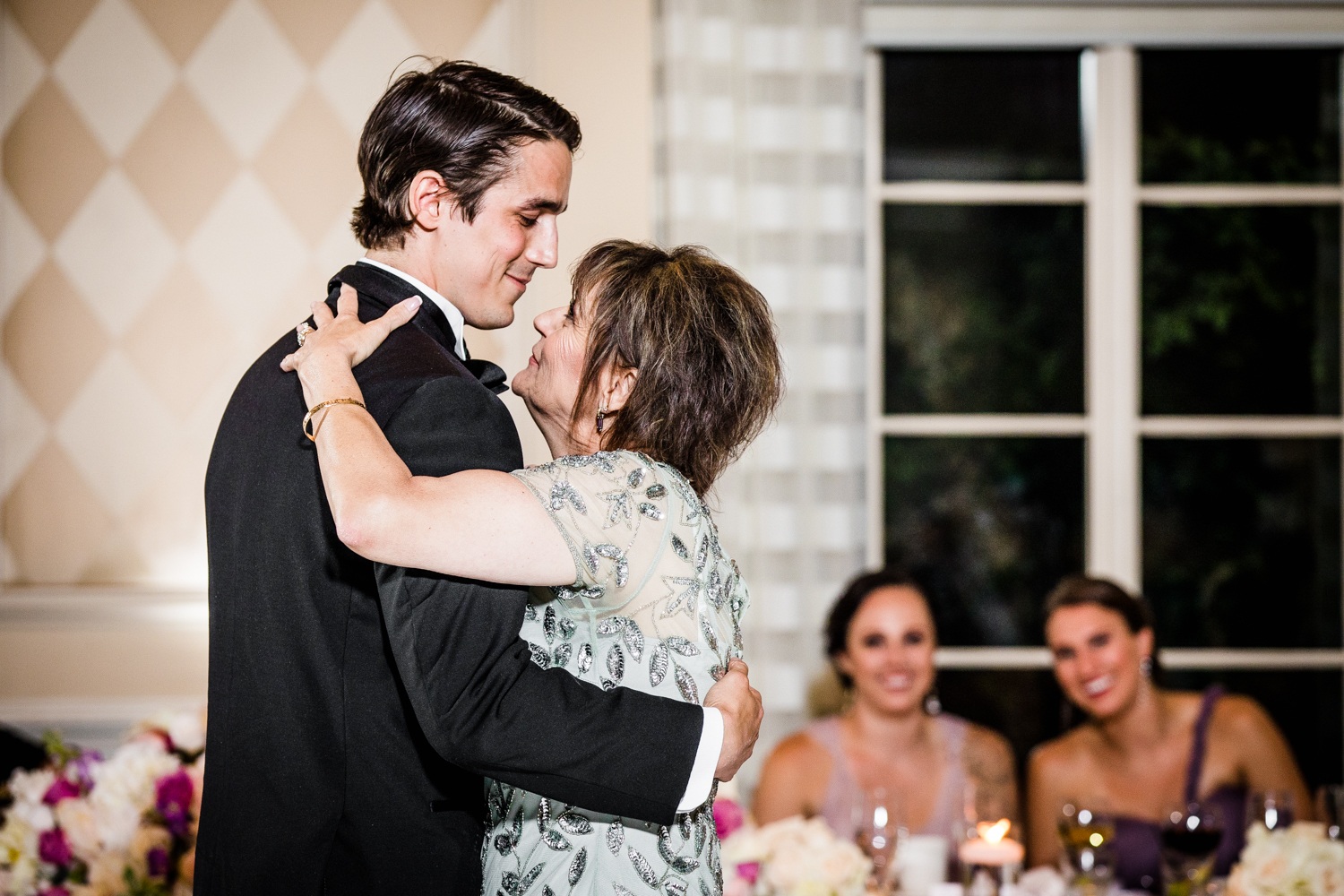 A groom shares his first dance with his mom during a Glen Club wedding reception. 