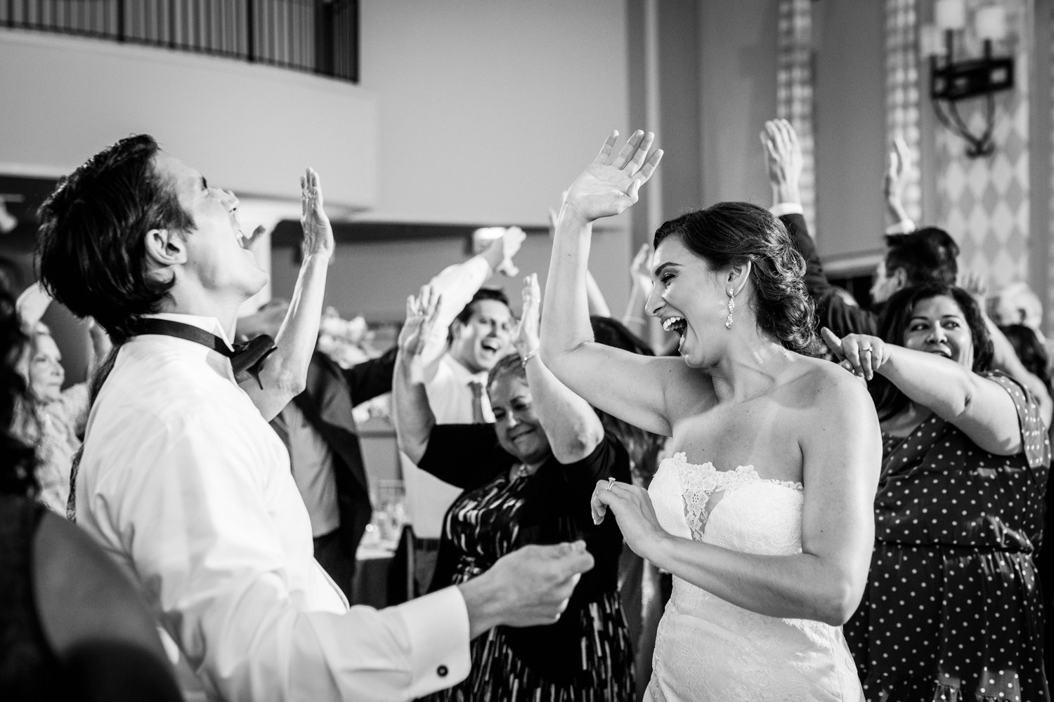 A bride and groom dance together with their guests during a Glen Club wedding reception. 