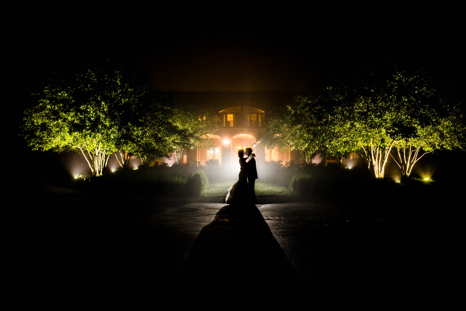 A couple portrait in silhouette at a Glen Club wedding reception.