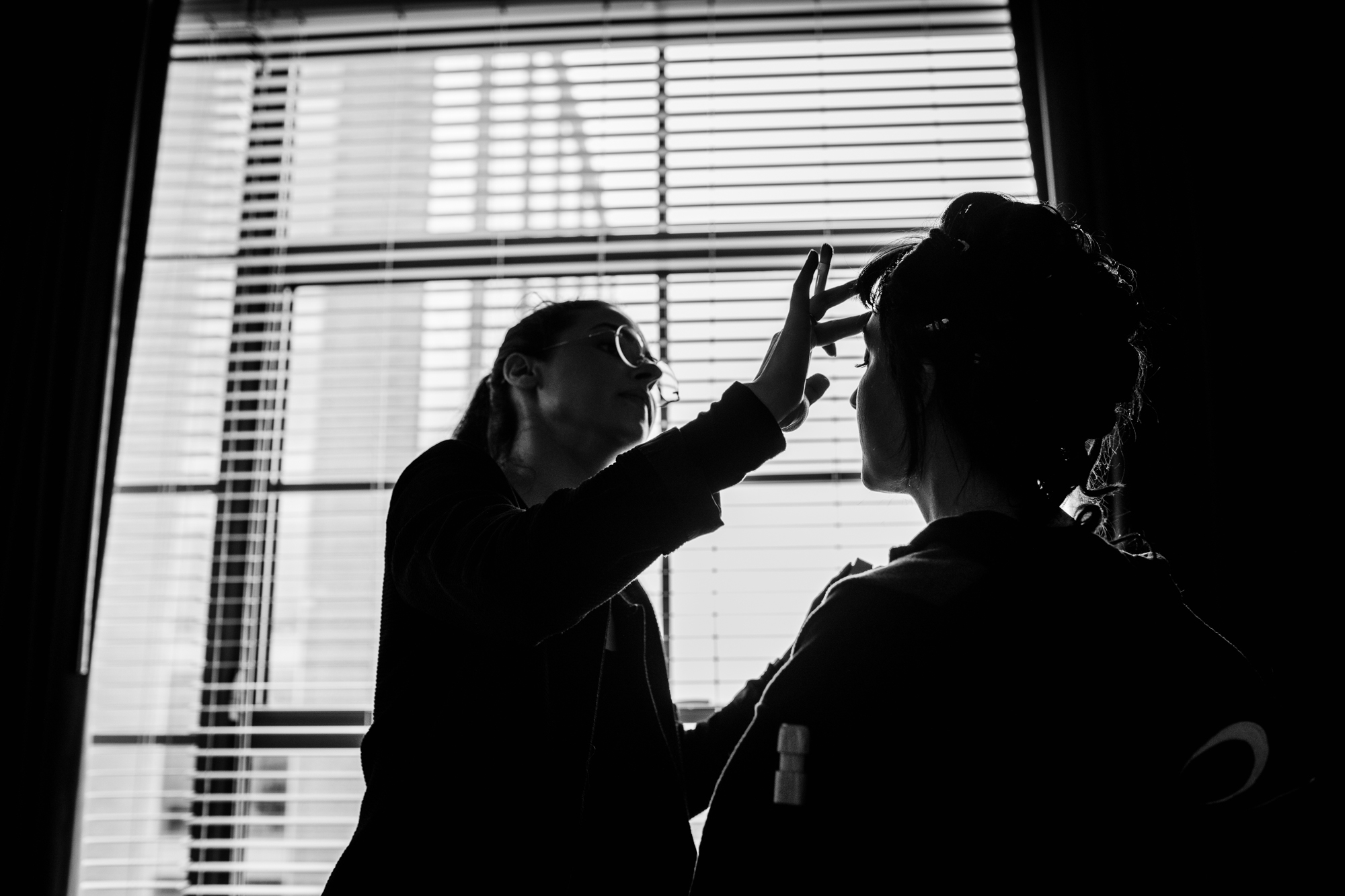 A bride in silhouette has her makeup done at the Ace Hotel in Chicago. 