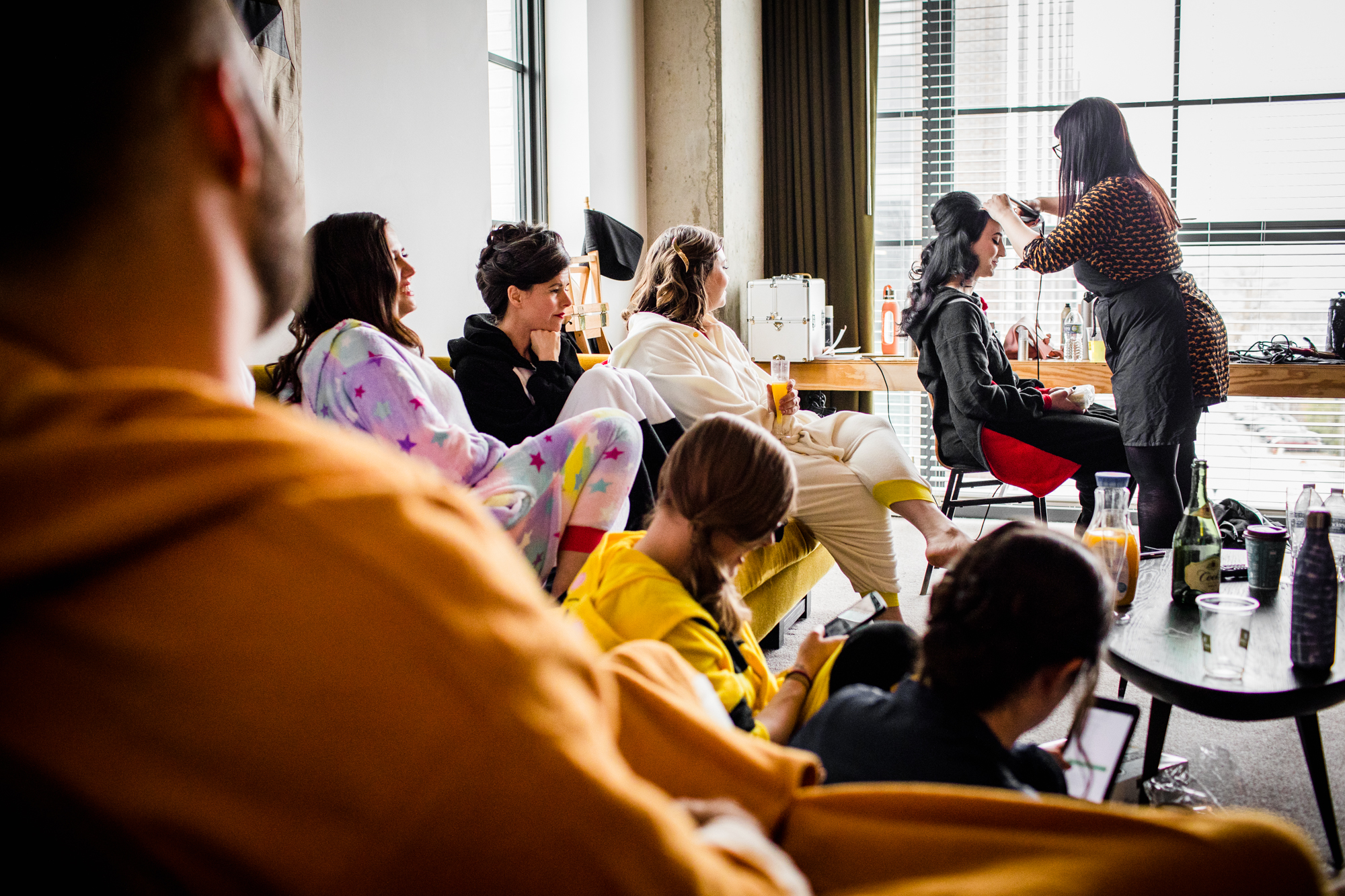 The wedding party watches as a bride gets her hair done at the Ace Hotel in Chicago. 