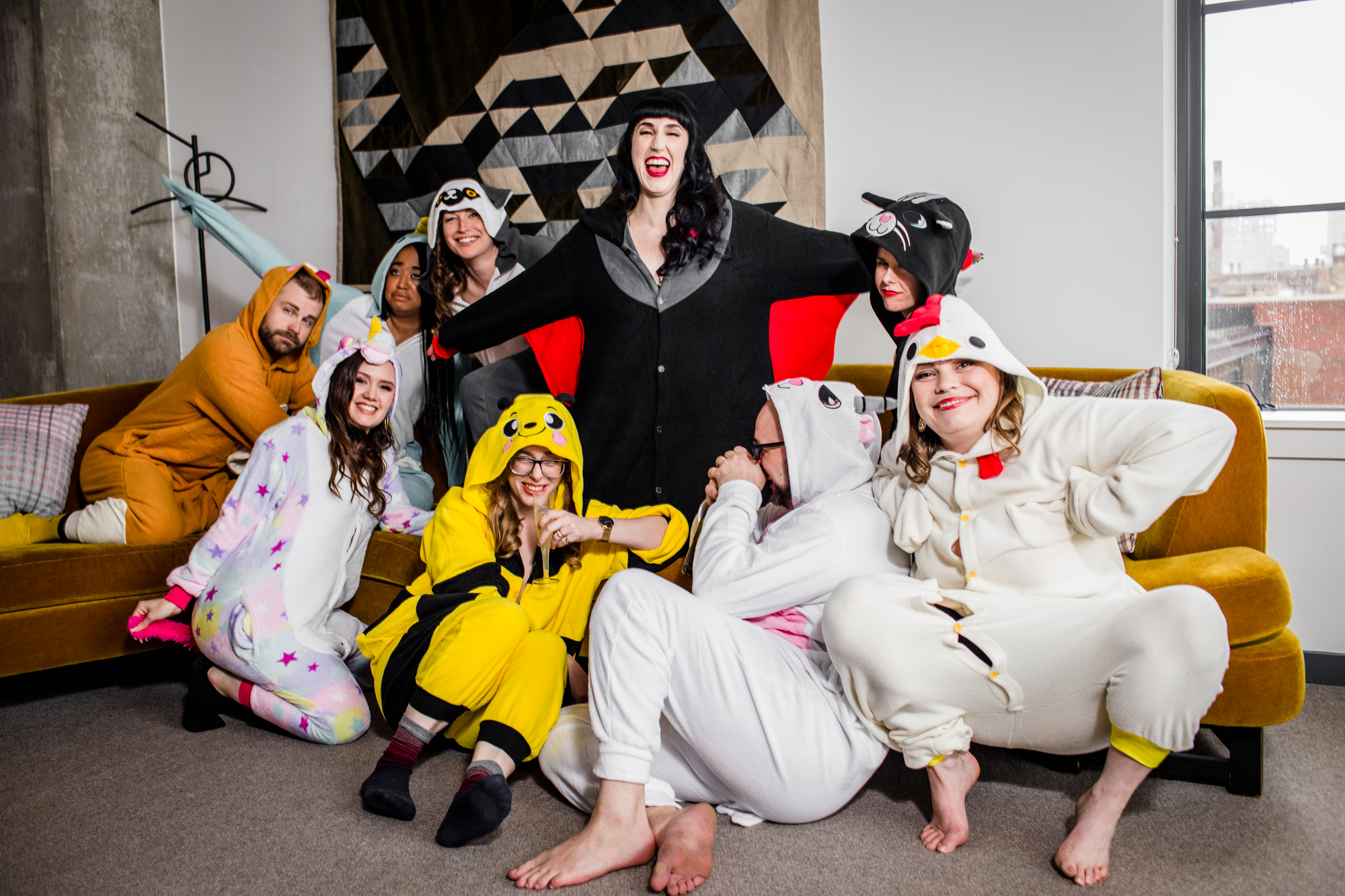 A bride and her wedding party laugh while wearing animal onesies while getting ready at the Ace Hotel in Chicago. 