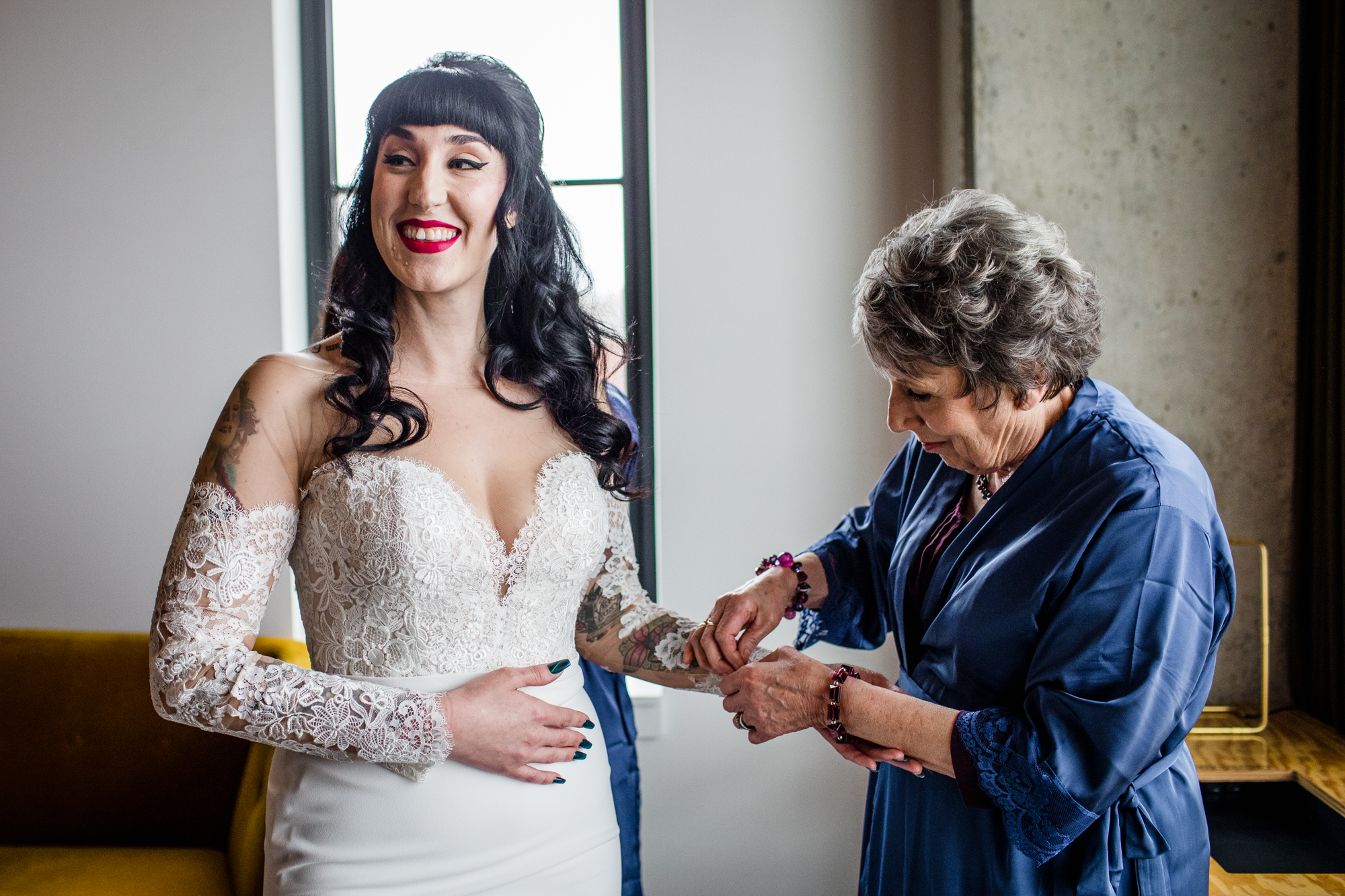 The grandmother of the bride helps her get into her dress at the Ace Hotel in Chicago. 
